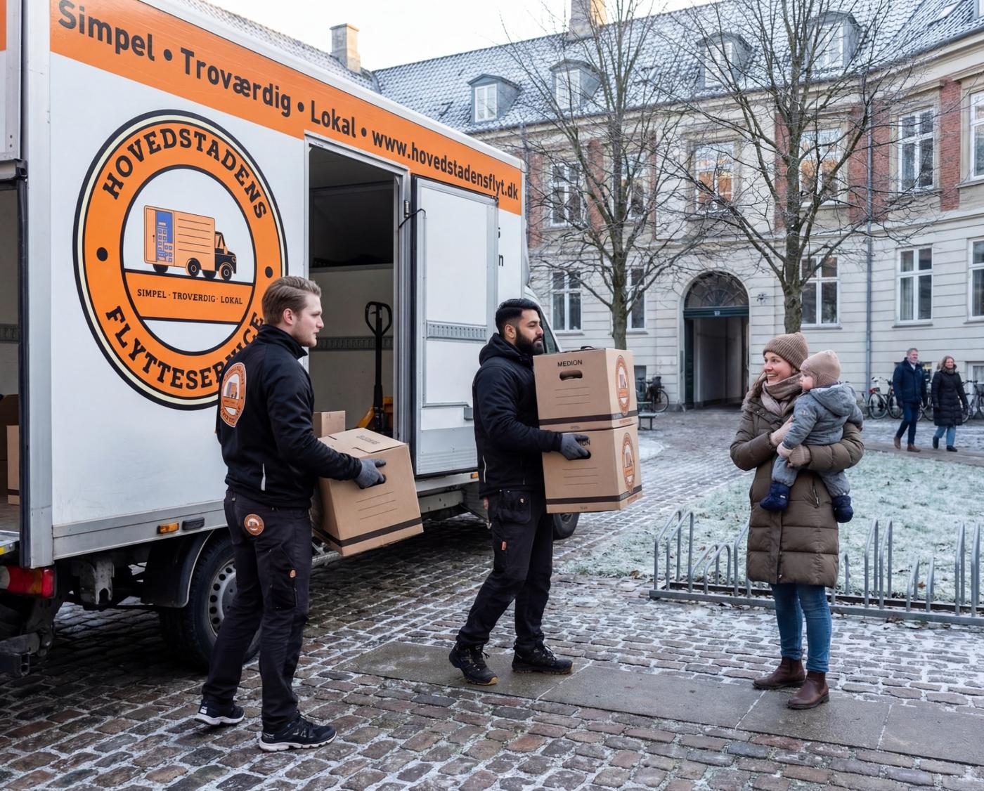 Flyttemænd fra Hovedstadens Flyt bærer møbler ud af en kassevogn